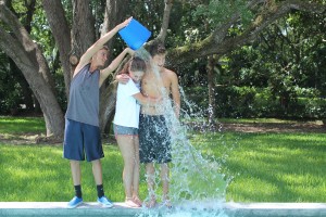 Junior Brian Gerstien and senior Corina Scheuren do the ice bucket challenge. Frehsman Trahern Gribble  pours the ice over their heads with a wry smile. 