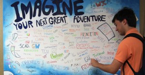 Senior Michael Estrada decorates the mural by adding his college acceptances.