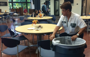 Maintenance taff member Elida cleans up messy table filled with plates and cups after sixth period lunch in the Student Union. Photo by Talia Pfeffer.