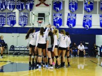 The girls volleyball team huddles up during one of their games. They currently have an 10-3 record, showing their early dominance. Key wins have come against Carrollton and Doral. Photo by Shannon Kunkel.